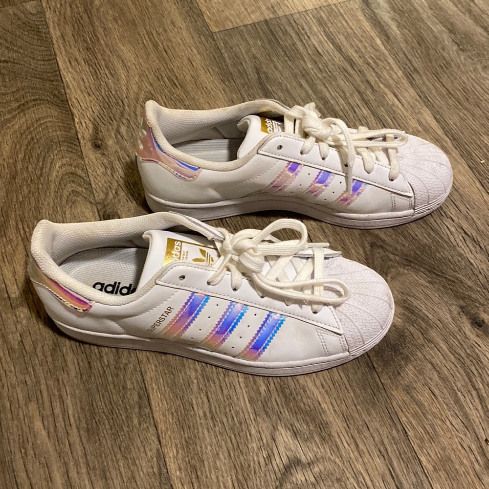 White and iridescent Adidas Superstar shoes